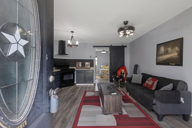 639 Manor St, Houston, TX 77015 - living area with a barn door, dark wood-style flooring, and a chandelier