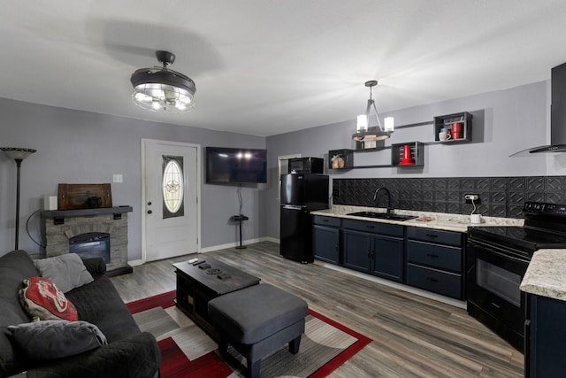 639 Manor St, Houston, TX 77015 - living area featuring a fireplace, wood finished floors, and a chandelier