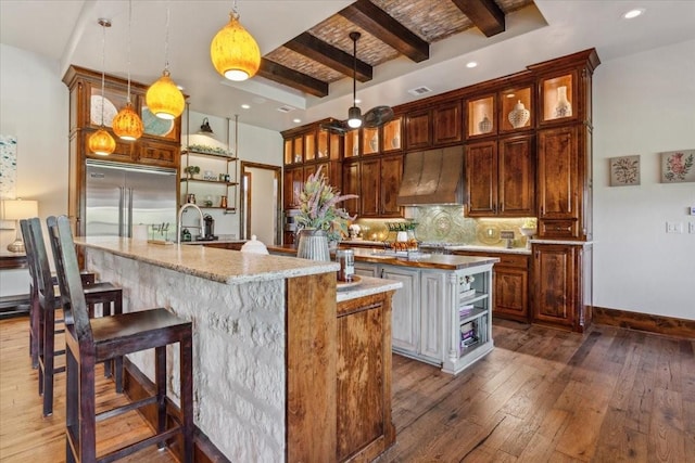 535 Creekside Dr, Salado, TX 76571 - kitchen featuring an island with sink, premium range hood, open shelves, stainless steel built in fridge, and beamed ceiling