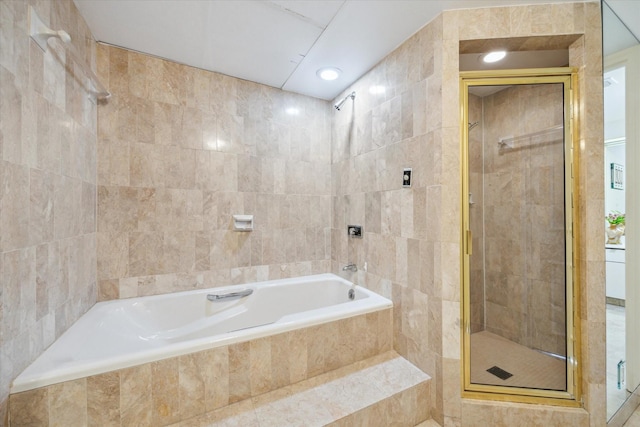 101 Westcott St Unit 305, Houston, TX 77007 - full bathroom with a tile shower, tile walls, and a relaxing tiled tub