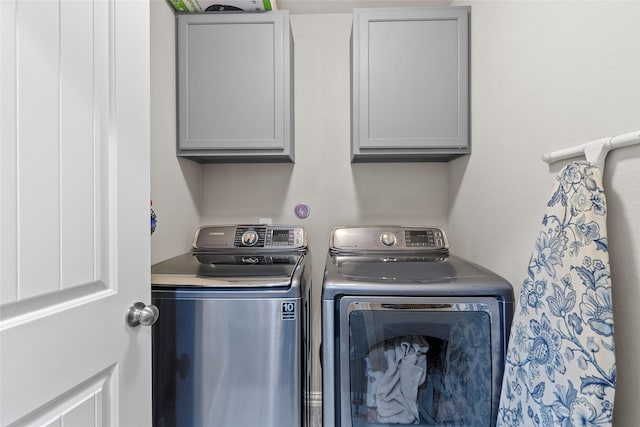 8992 S Comanche Cir, Willis, TX 77378 - laundry area with washing machine and dryer and cabinet space