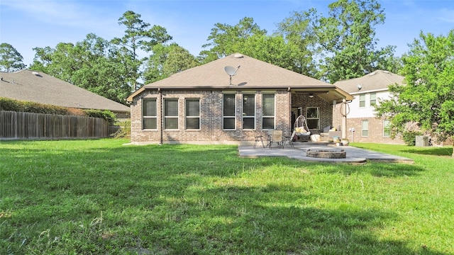 8992 S Comanche Cir, Willis, TX 77378 - back of property with a patio, brick siding, and an outdoor fire pit