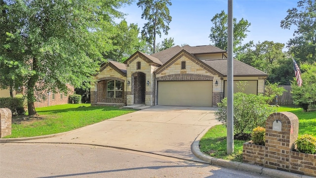 8992 S Comanche Cir, Willis, TX 77378 - view of front facade featuring stone siding, a garage, driveway, brick siding, and a shingled roof