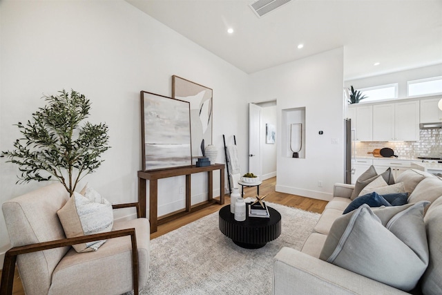 2208 Dennis St, Houston, TX 77004 - living room featuring light wood-style floors, recessed lighting, and baseboards