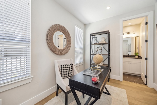 2208 Dennis St, Houston, TX 77004 - office featuring light wood-type flooring, plenty of natural light, baseboards, recessed lighting, and a sink