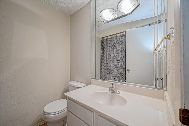 11605 Southlake Dr Unit 32, Houston, TX 77077 - bathroom with toilet, vanity, and a textured ceiling