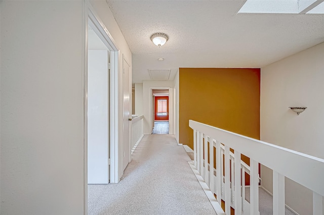 11605 Southlake Dr Unit 32, Houston, TX 77077 - corridor with attic access, light carpet, and a textured ceiling