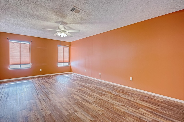 11605 Southlake Dr Unit 32, Houston, TX 77077 - spare room featuring wood finished floors, a ceiling fan, a textured ceiling, and baseboards
