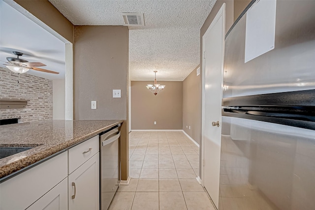 11605 Southlake Dr Unit 32, Houston, TX 77077 - kitchen featuring stainless steel dishwasher, a textured ceiling, a ceiling fan, white cabinetry, and light tile patterned floors