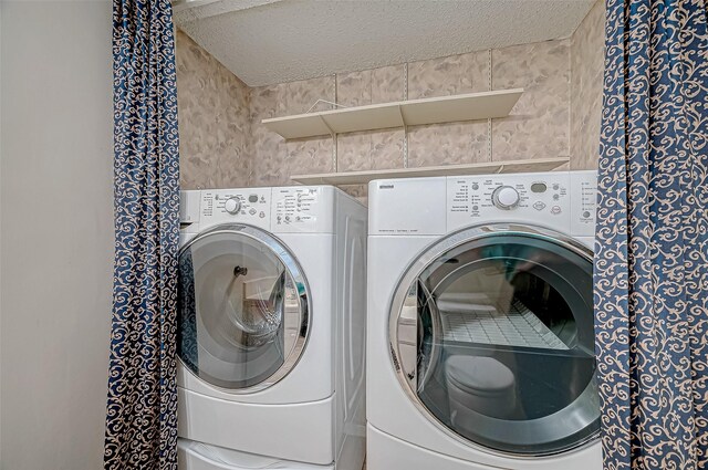 11605 Southlake Dr Unit 32, Houston, TX 77077 - laundry area featuring a textured ceiling and separate washer and dryer