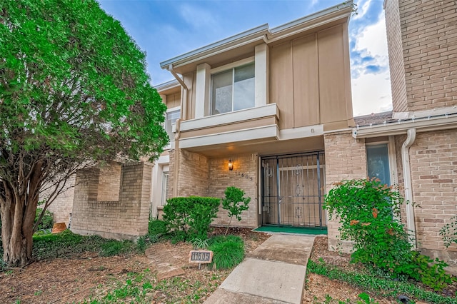 11605 Southlake Dr Unit 32, Houston, TX 77077 - doorway to property with brick siding and board and batten siding