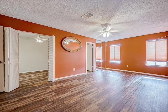 11605 Southlake Dr Unit 32, Houston, TX 77077 - spare room featuring ceiling fan, wood finished floors, a textured ceiling, and baseboards