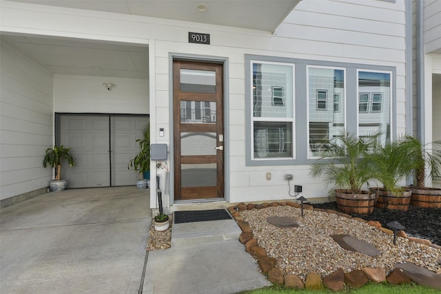 9013 Lonestar Creekbend Ln, Houston, TX 77080 - view of exterior entry with driveway and a garage