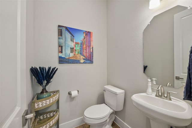 9013 Lonestar Creekbend Ln, Houston, TX 77080 - half bathroom with toilet, a sink, baseboards, and wood finished floors