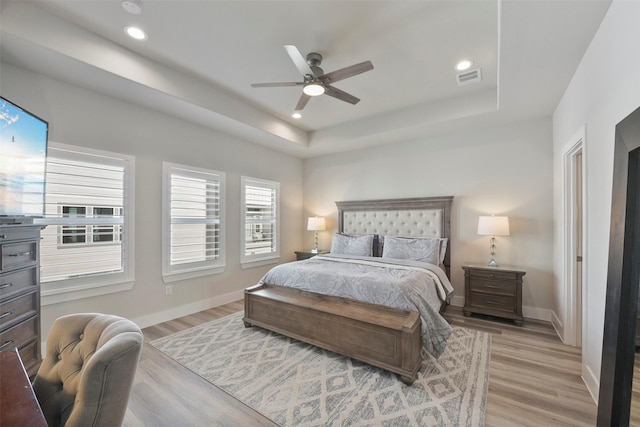 9013 Lonestar Creekbend Ln, Houston, TX 77080 - bedroom with a raised ceiling, light wood finished floors, baseboards, recessed lighting, and a ceiling fan