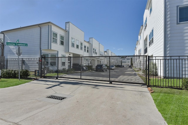 9013 Lonestar Creekbend Ln, Houston, TX 77080 - view of concrete driveway featuring a gate