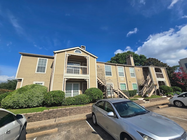 1860 White Oak Dr Unit 314, Houston, TX 77009 - view of building exterior featuring uncovered parking and stairs