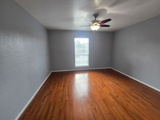 1860 White Oak Dr Unit 314, Houston, TX 77009 - empty room featuring baseboards, wood finished floors, a ceiling fan, and a textured wall