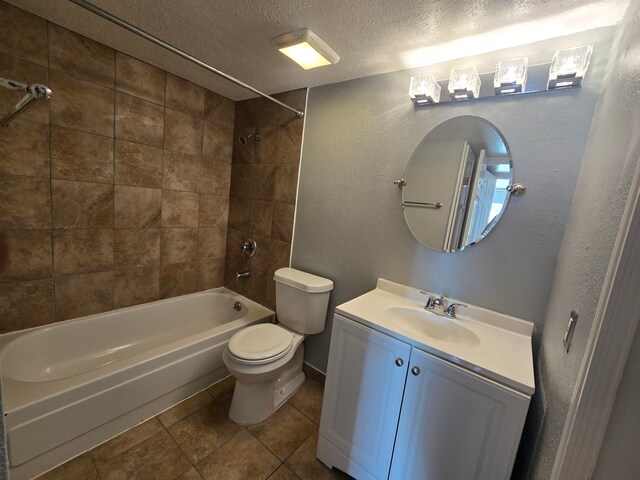 1860 White Oak Dr Unit 314, Houston, TX 77009 - full bathroom featuring a textured ceiling, bathtub / shower combination, toilet, vanity, and tile patterned flooring