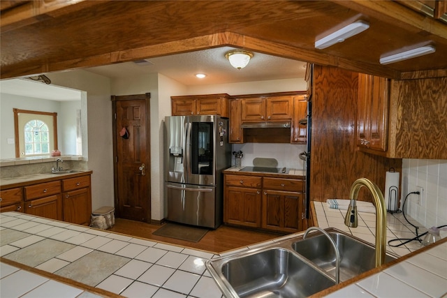 4746 County Road 502d, Sweeny, TX 77480 - kitchen with stainless steel fridge with ice dispenser, tile countertops, black electric stovetop, and a sink
