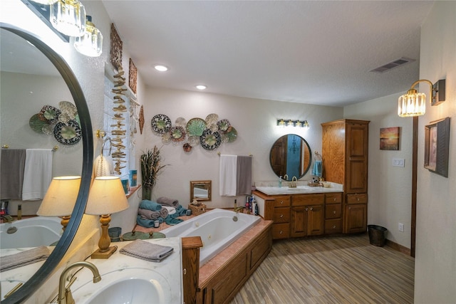 4746 County Road 502d, Sweeny, TX 77480 - full bathroom featuring vanity, a jetted tub, recessed lighting, and wood finished floors