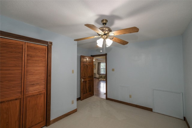 4746 County Road 502d, Sweeny, TX 77480 - unfurnished bedroom with light carpet, baseboards, a closet, and a ceiling fan