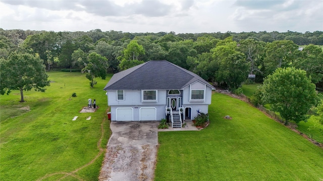 4746 County Road 502d, Sweeny, TX 77480 - view of front of house featuring an attached garage, asphalt driveway, a front yard, and a wooded view