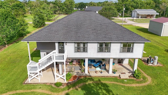 4746 County Road 502d, Sweeny, TX 77480 - back of property featuring a patio, roof with shingles, and a lawn