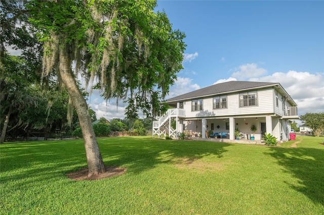 4746 County Road 502d, Sweeny, TX 77480 - back of property with stairs, a yard, and a patio area