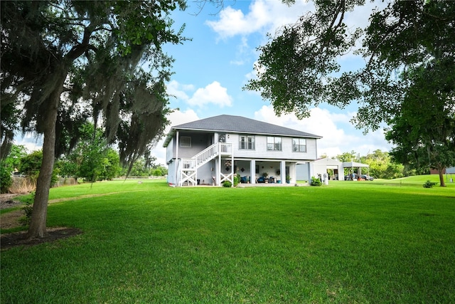 4746 County Road 502d, Sweeny, TX 77480 - back of house featuring stairs and a lawn