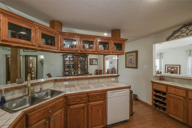 4746 County Road 502d, Sweeny, TX 77480 - kitchen with tile countertops, dishwasher, a sink, and a textured ceiling