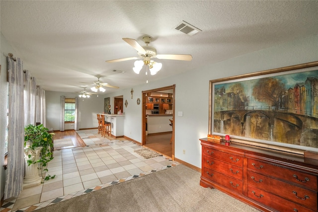 4746 County Road 502d, Sweeny, TX 77480 - living room with light tile patterned flooring, baseboards, ceiling fan, and a textured ceiling