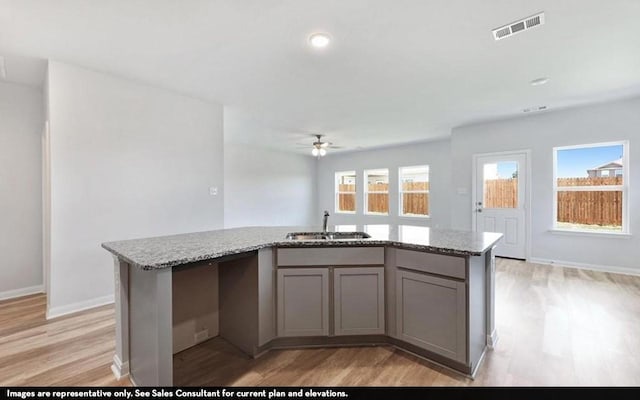 3523 Prairie Rose Trl, Angleton, TX 77515 - kitchen featuring a sink, light wood-style flooring, ceiling fan, light stone counters, and recessed lighting