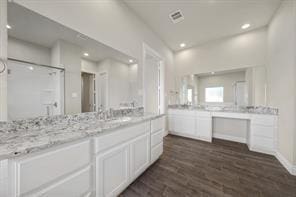 9314 Brunel Ln, Houston, TX 77044 - full bathroom with vanity, wood finished floors, a shower stall, and recessed lighting