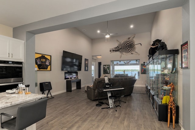 9314 Brunel Ln, Houston, TX 77044 - living room with light wood-style flooring, recessed lighting, a ceiling fan, and a towering ceiling