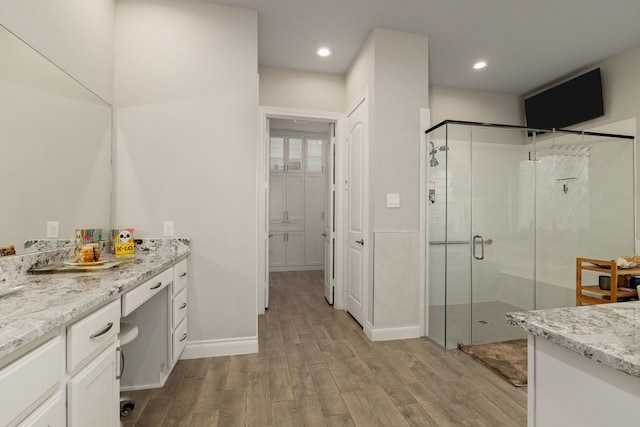 9314 Brunel Ln, Houston, TX 77044 - full bath with wood finished floors, vanity, a stall shower, and recessed lighting