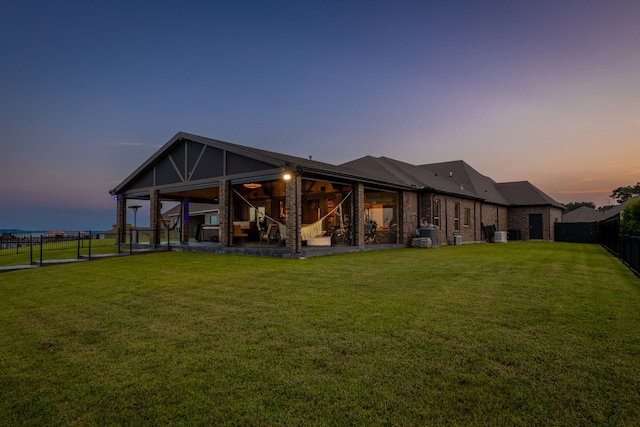 9314 Brunel Ln, Houston, TX 77044 - back of property at dusk with a fenced backyard, a patio, and brick siding