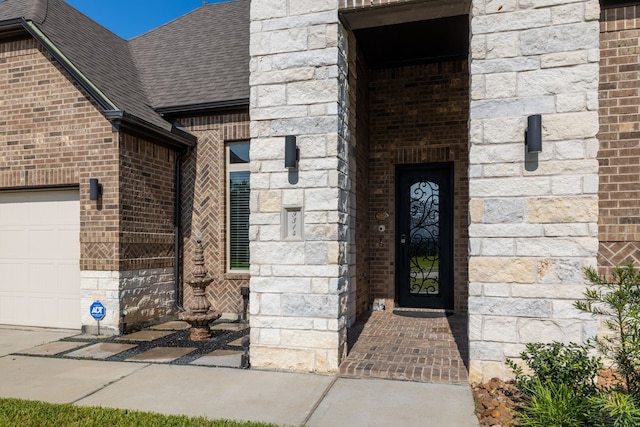 9314 Brunel Ln, Houston, TX 77044 - property entrance featuring brick siding, a shingled roof, and stone siding