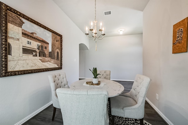 5307 Cascade Ct, Alvin, TX 77511 - dining room with a chandelier, arched walkways, baseboards, dark wood-style flooring, and vaulted ceiling