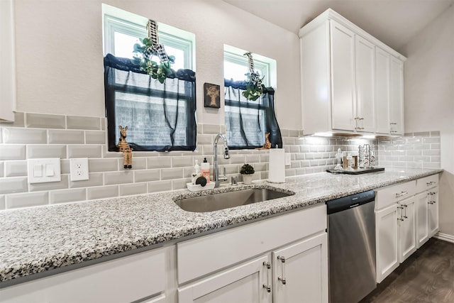 5307 Cascade Ct, Alvin, TX 77511 - kitchen with stainless steel dishwasher, a sink, white cabinets, light stone counters, and dark wood-style floors