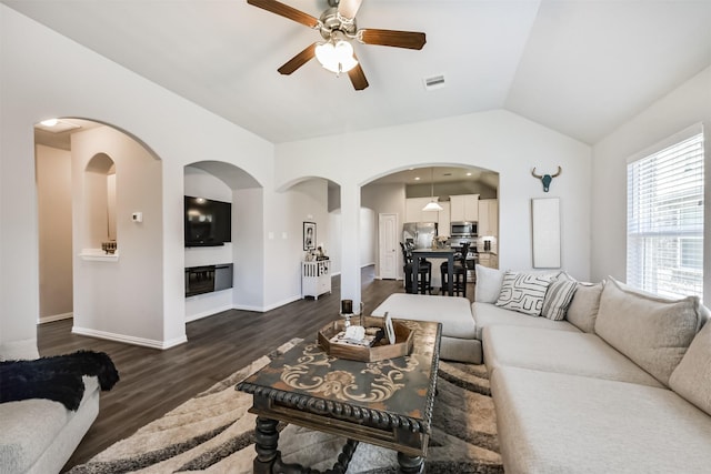 5307 Cascade Ct, Alvin, TX 77511 - living area featuring arched walkways, ceiling fan, dark wood finished floors, vaulted ceiling, and baseboards