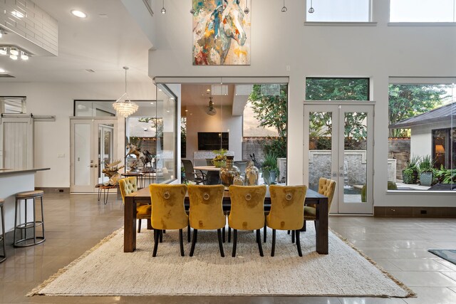 507 Terrace Dr, Houston, TX 77007 - dining space with french doors, tile patterned floors, a towering ceiling, and recessed lighting