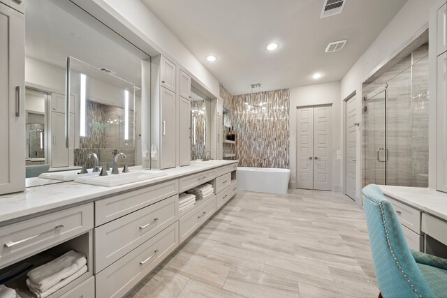 507 Terrace Dr, Houston, TX 77007 - full bathroom featuring double vanity, a freestanding bath, a shower stall, recessed lighting, and a chandelier
