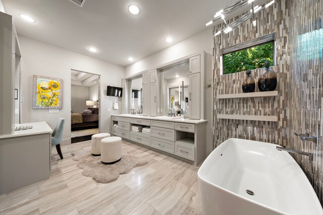 507 Terrace Dr, Houston, TX 77007 - ensuite bathroom featuring a soaking tub, vanity, and recessed lighting