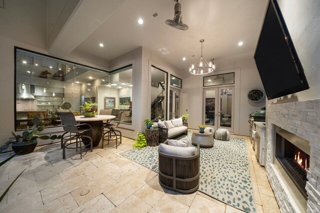 507 Terrace Dr, Houston, TX 77007 - living area featuring a chandelier, a stone fireplace, recessed lighting, and stone tile flooring