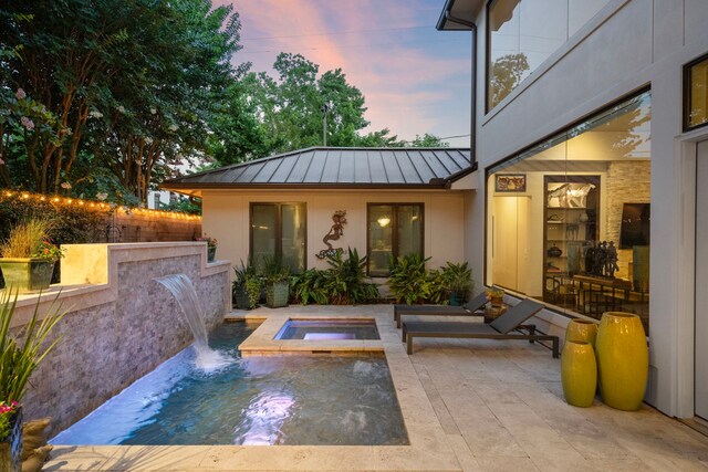 507 Terrace Dr, Houston, TX 77007 - pool at dusk with an in-ground hot tub and a patio area