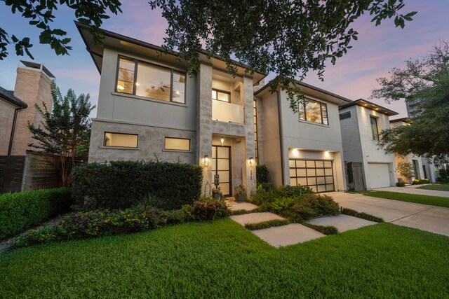 507 Terrace Dr, Houston, TX 77007 - contemporary house featuring concrete driveway, a garage, and stucco siding