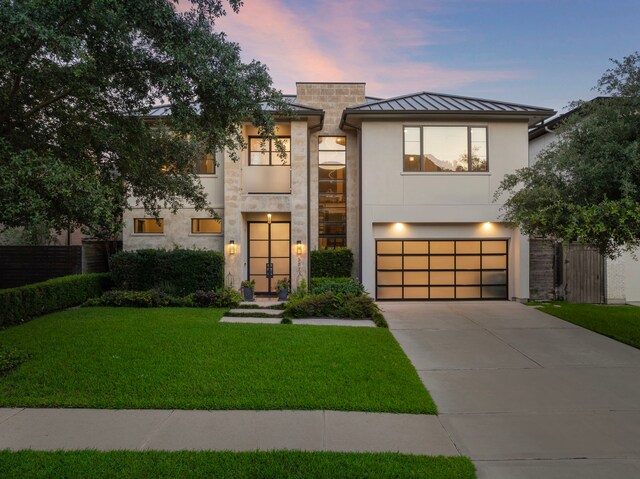 507 Terrace Dr, Houston, TX 77007 - modern home featuring a standing seam roof, an attached garage, concrete driveway, metal roof, and stucco siding