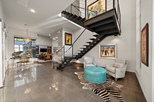 507 Terrace Dr, Houston, TX 77007 - staircase featuring baseboards, tile patterned floors, recessed lighting, and a high ceiling