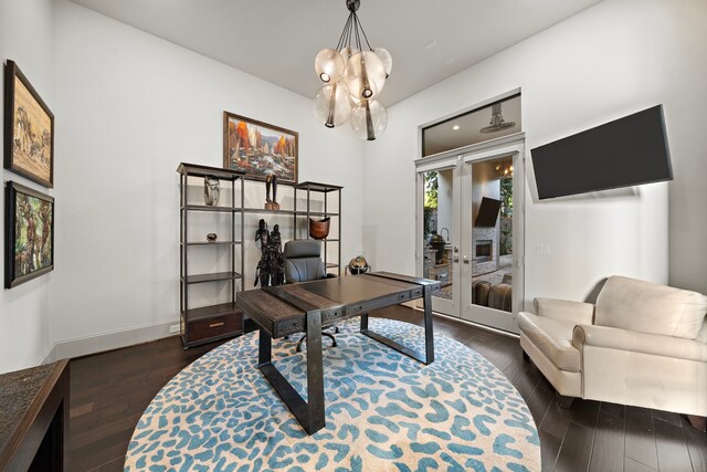 507 Terrace Dr, Houston, TX 77007 - office space featuring dark wood finished floors, a chandelier, baseboards, and a fireplace